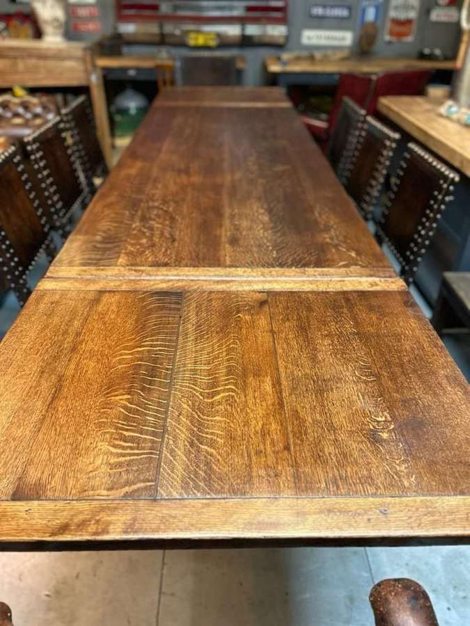 12 seater oak extending refectory table with 8 antique leather chairs