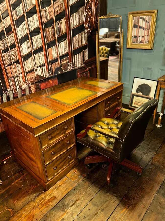 Antique Walnut pedestal desk with a hinged compartment desk with olive green leather top.