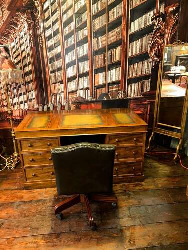 Antique Walnut pedestal desk with a hinged compartment desk with olive green leather top.