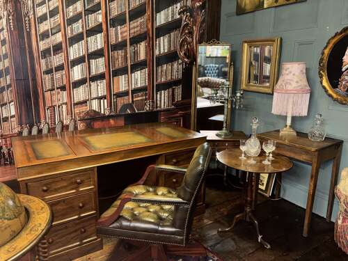 Antique Walnut pedestal desk with a hinged compartment desk with olive green leather top.