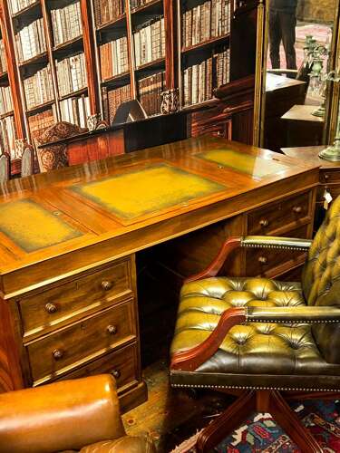 Antique Walnut pedestal desk with a hinged compartment desk with olive green leather top.