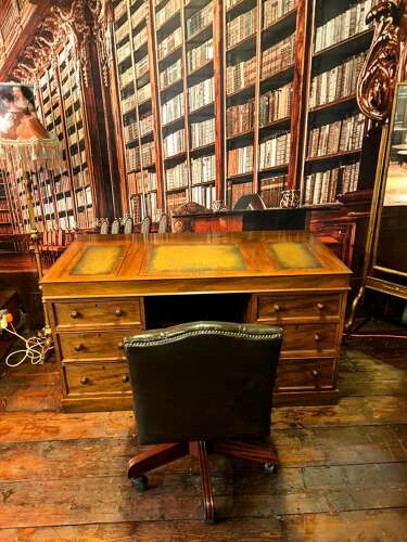 Antique Walnut pedestal desk with a hinged compartment desk with olive green leather top.
