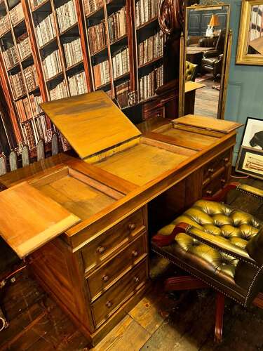 Antique Walnut pedestal desk with a hinged compartment desk with olive green leather top.