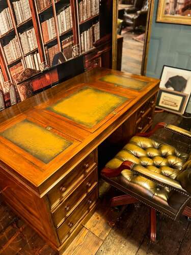 Antique Walnut pedestal desk with a hinged compartment desk with olive green leather top.