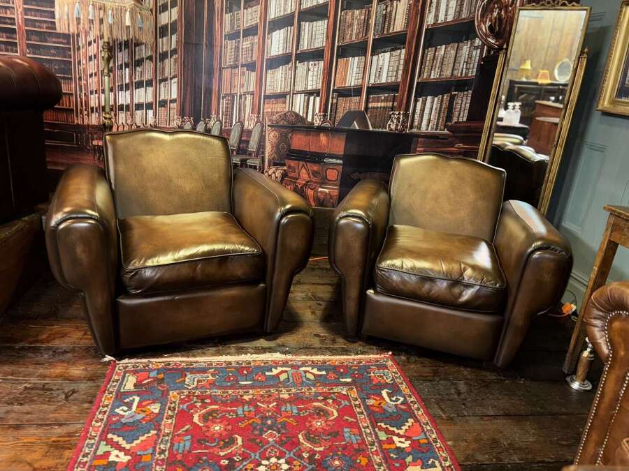 Matching pair of moustache back leather chairs