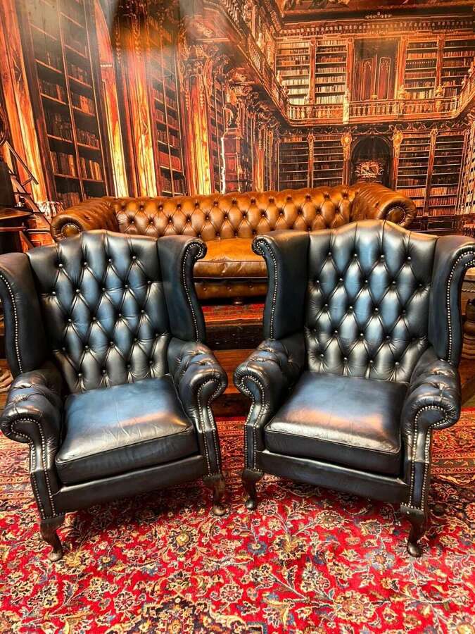 Matching pair of blue leather wing armchairs