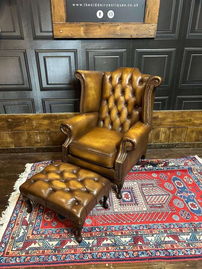 Tan leather Chesterfield wing armchair & matching footstool