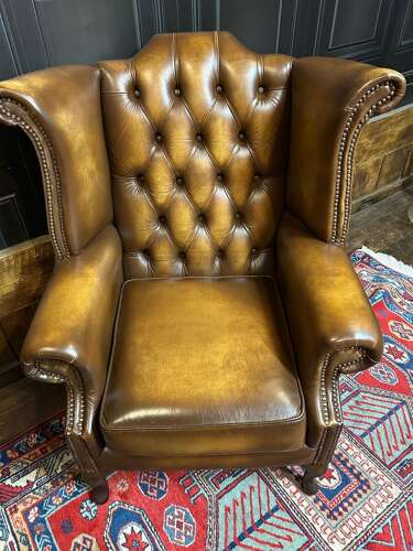 Tan leather Chesterfield wing armchair & matching footstool