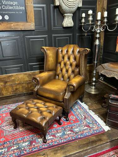 Tan leather Chesterfield wing armchair & matching footstool