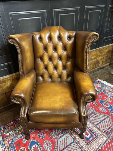 Tan leather Chesterfield wing armchair & matching footstool