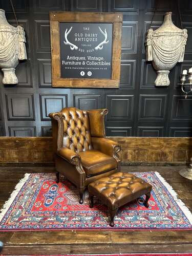 Tan leather Chesterfield wing armchair & matching footstool